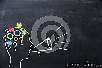 Coaching concept â€“ knowledge and ideas sharing with human head shape and megaphone or bullhorn on blackboard Stock Photo